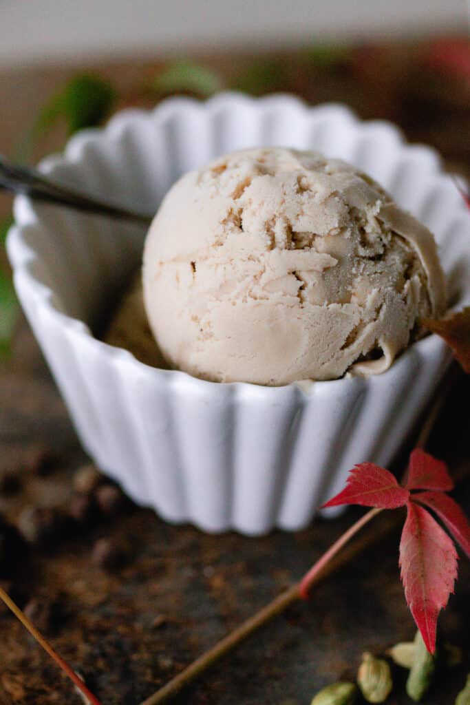 close up of a scoop of chai ice cream in a white bowl