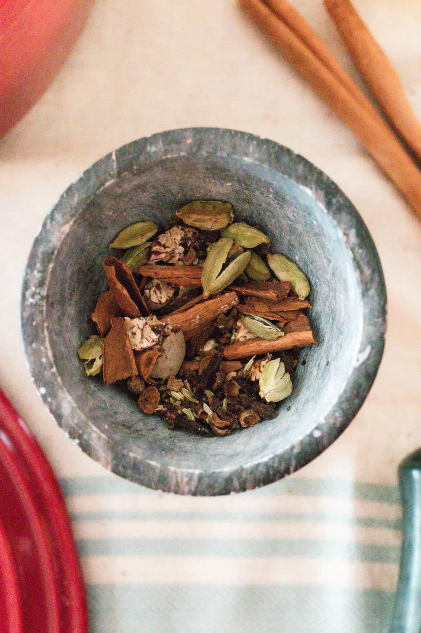 Chai spices in a pestle bowl.