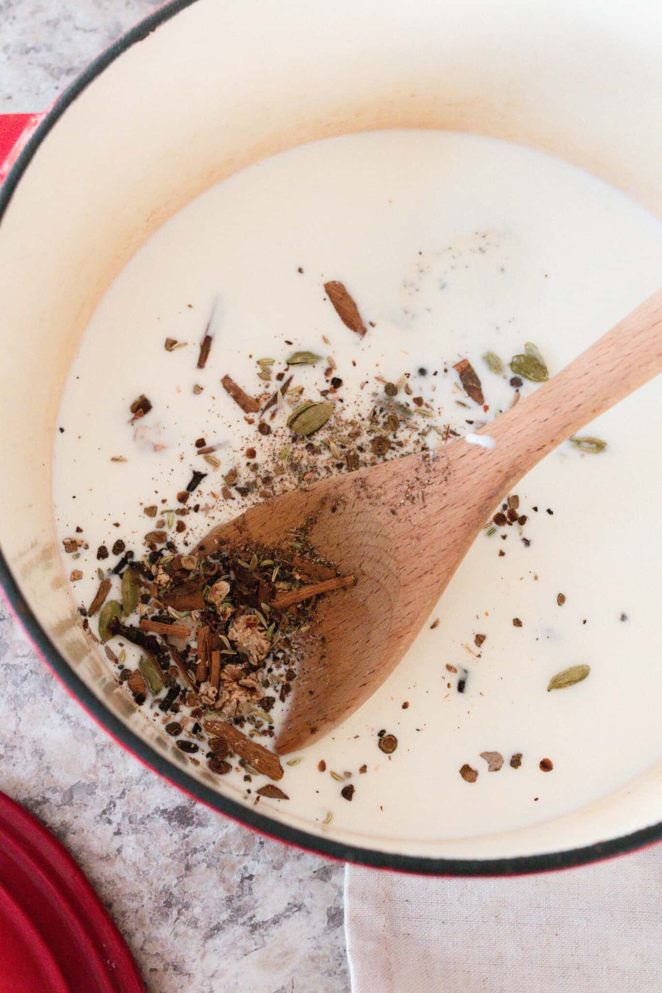 Milk steeping with chai spices to make ice cream.