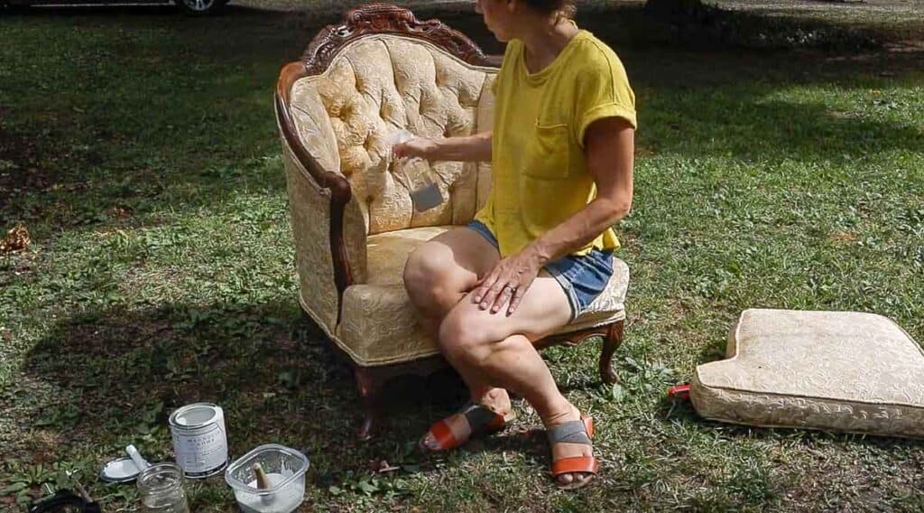 women spraying a chair with water to start chalk painting