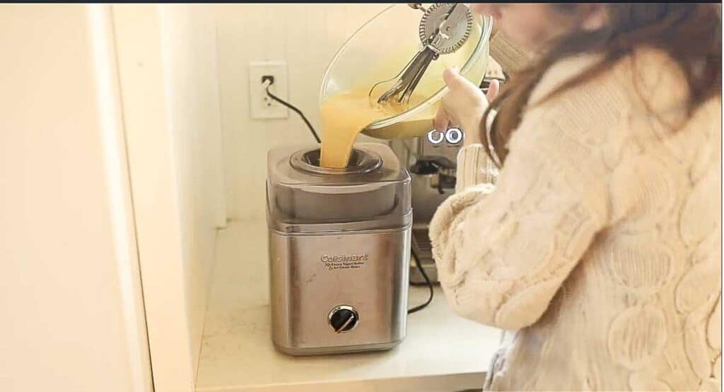 Pouring custard into an ice cream maker.