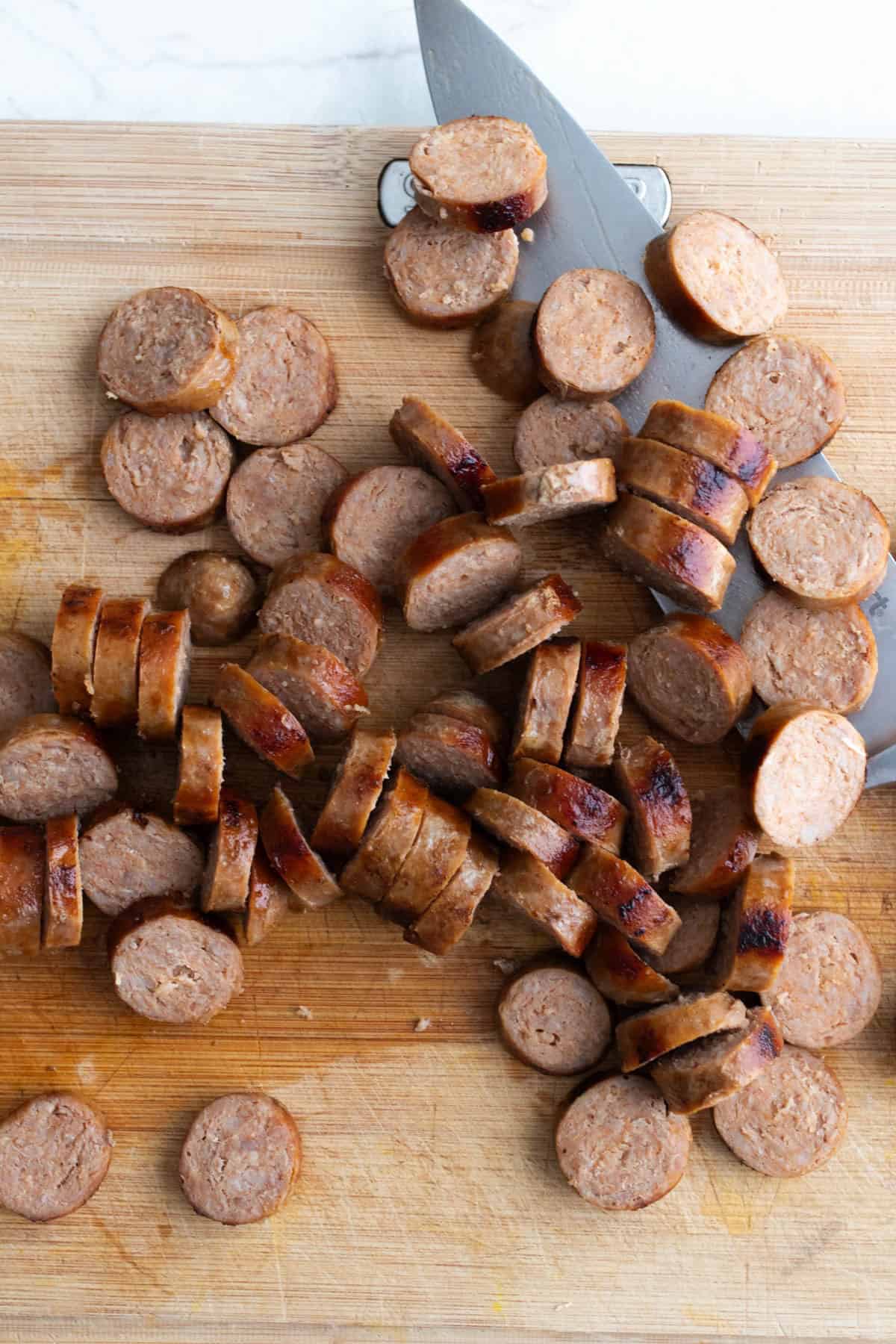 Sausage diced on a cutting board.