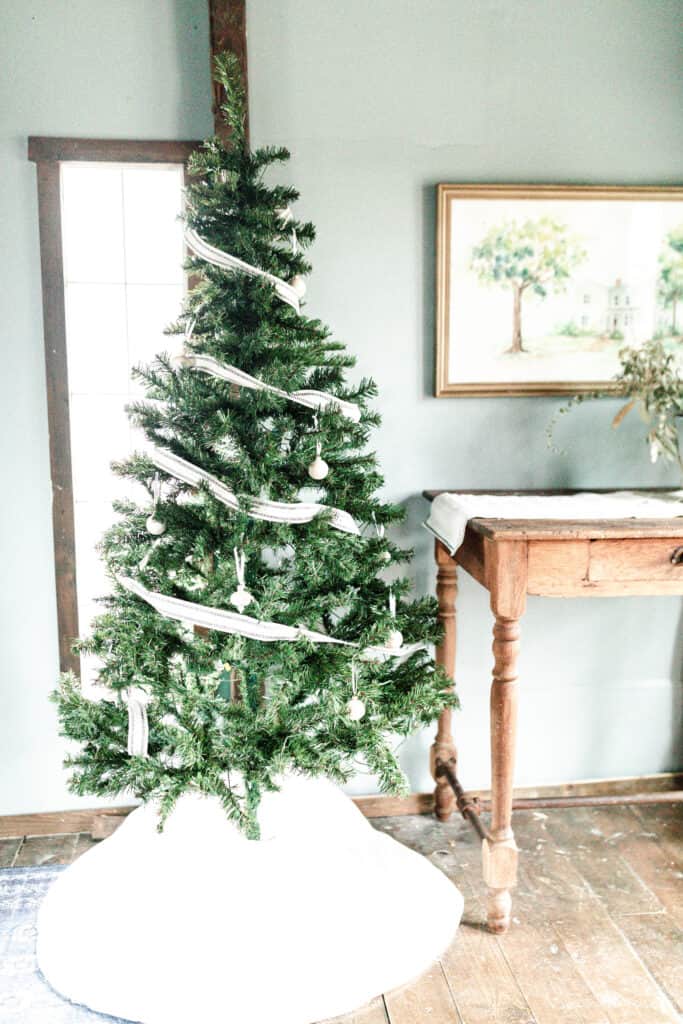 faux Christmas tree with burlap ribbon and whit wooden ornaments