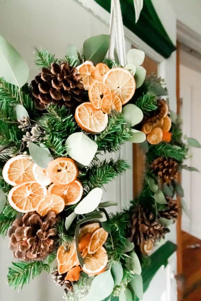 side view of a DIY Christmas wreath made with eucalyptus, dried oranges and pine cones