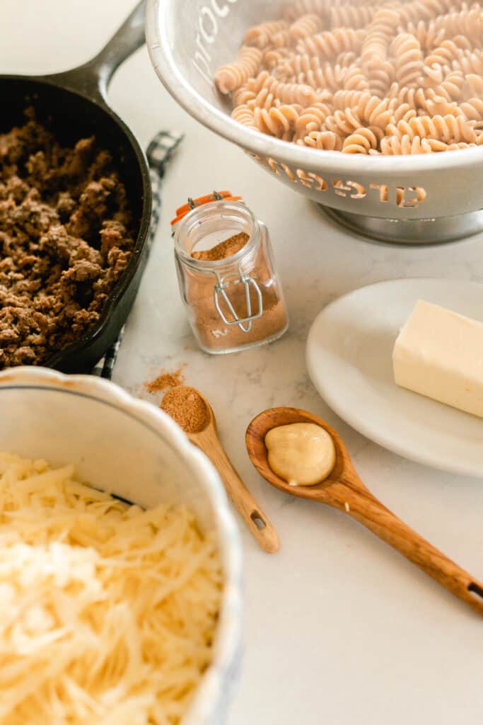 ingredients needed to make healthy hamburger helper on a white quarts countertop