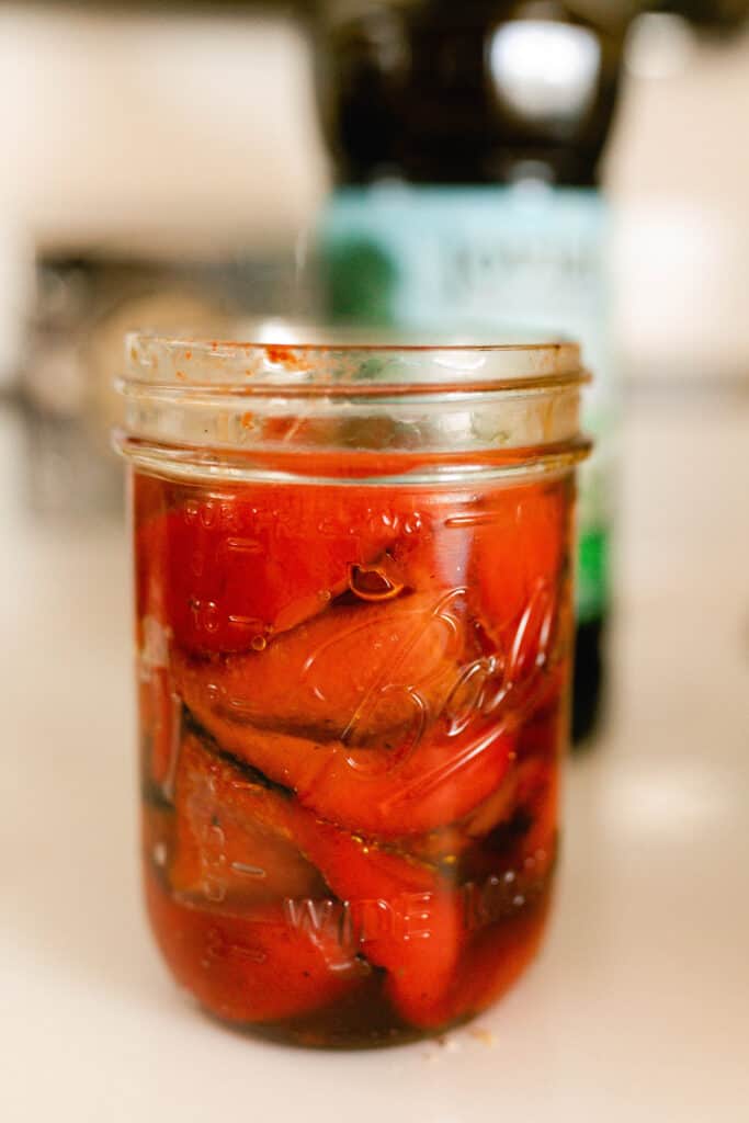 roasted red peppers in a jar with olive oil