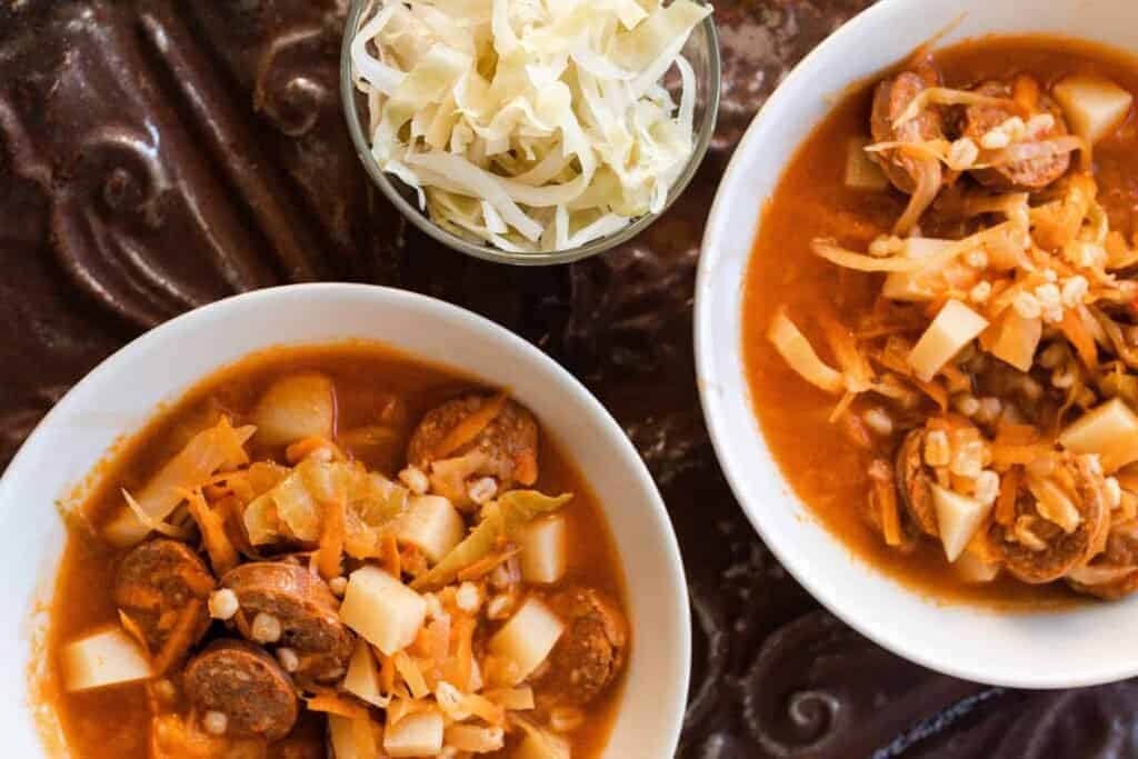 two bowls of sausage sauerkraut soup