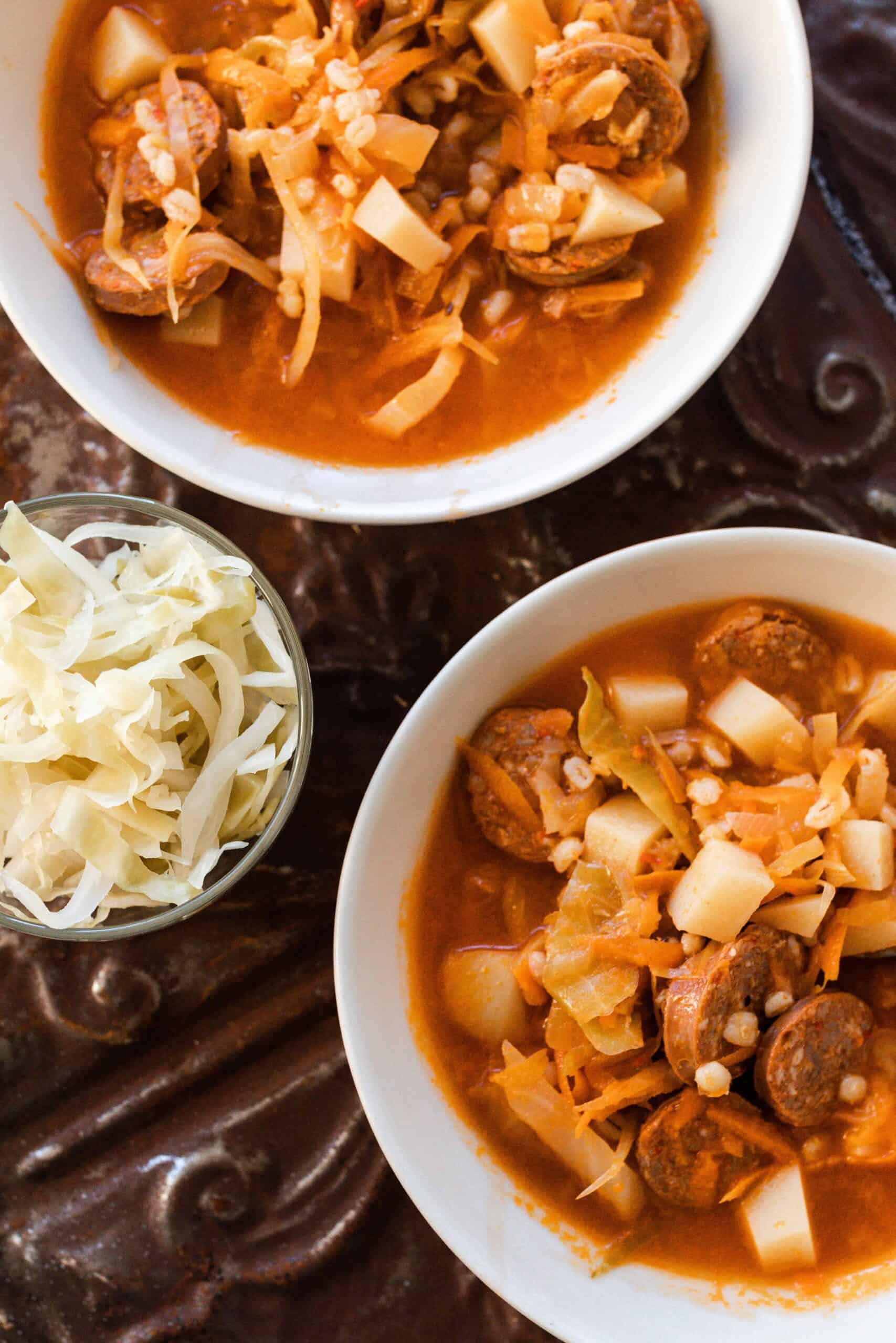 two bowls of sausage sauerkraut soup