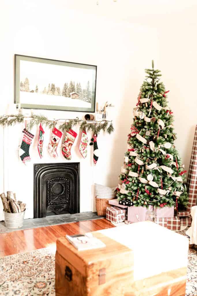 farmhouse Christmas decor in a living room with green, white, and reds