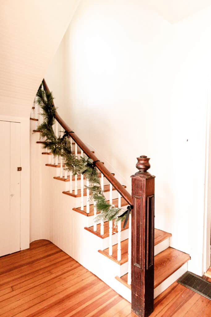 green garland wrapping a farmhouse staircase