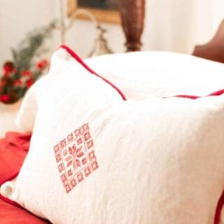 beautiful white an red pillow cases on a victorian style vintage bed with red and white linens