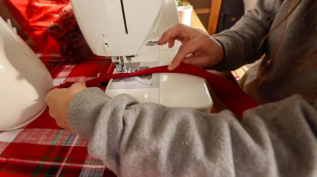 women sewing piping with red fabric and cotton cording