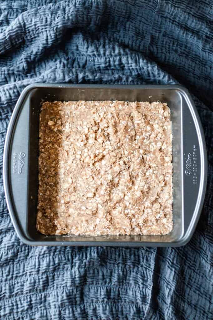 crumble pressed down in the bottom of a pan