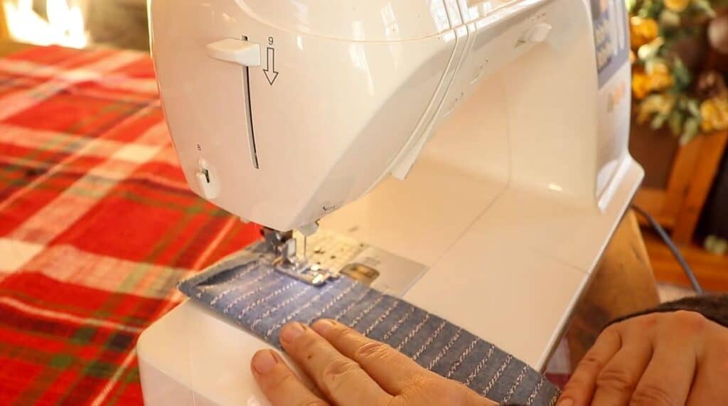 women sewing a apron strap with a sewing machine