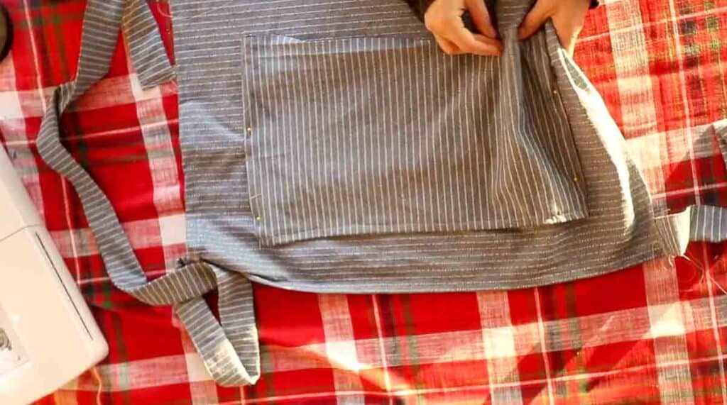 pinning a pocket onto a half apron