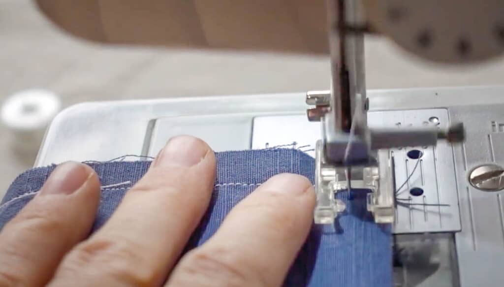 sewing a seam around a corner on blue fabric