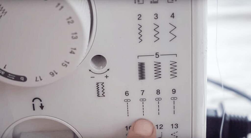 finger pointing to sewing machine stitch options