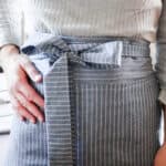 women wearing a blue and white stripped half apron with a bow tied in the front