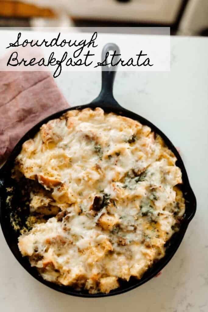 overhead photo of sourdough breakfast strata in a cast iron skillet on a red tea towel on a white quartz countertop
