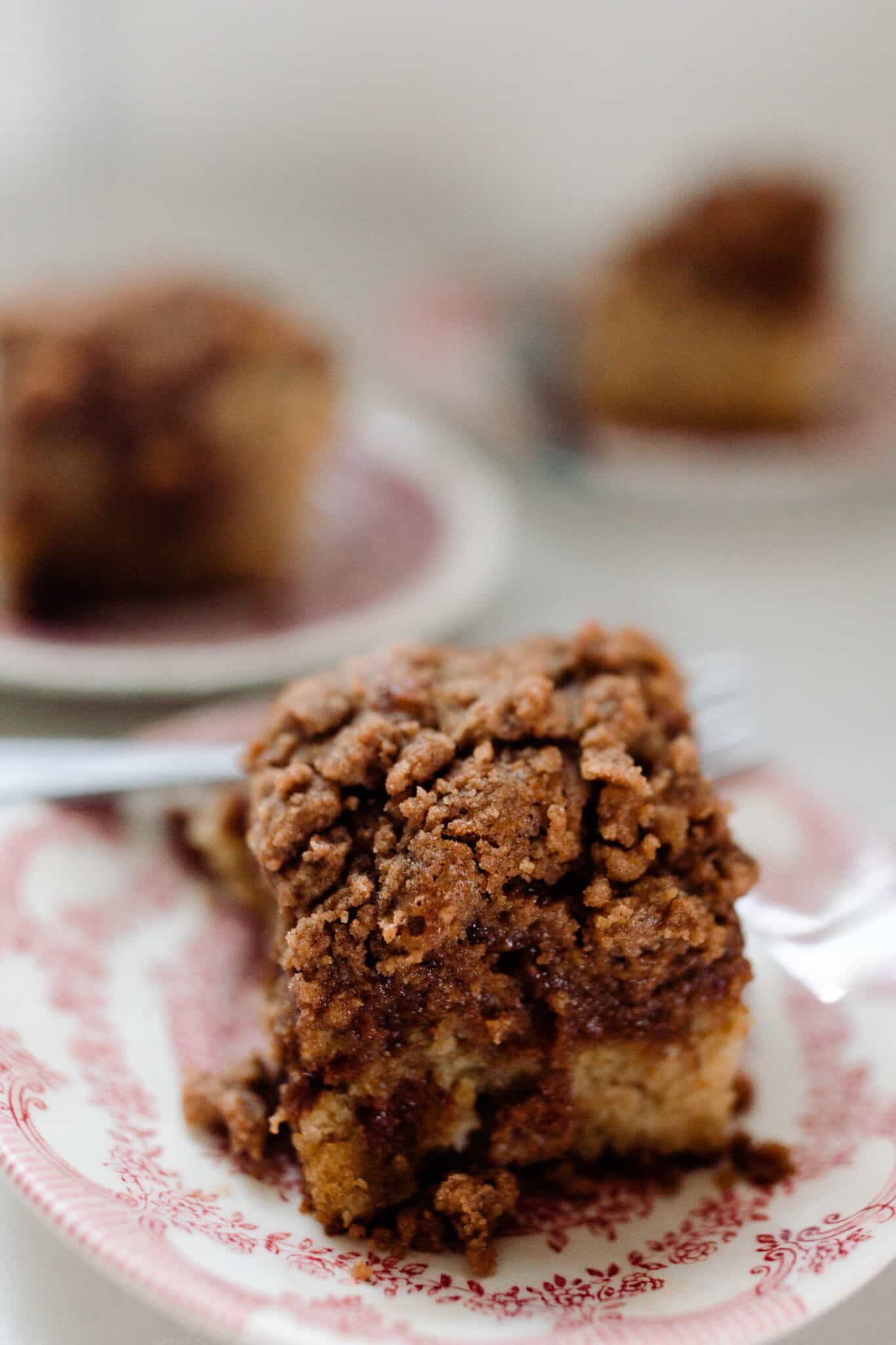 sourdough coffee cake with cinnamon crumble on a white and red vintage plates
