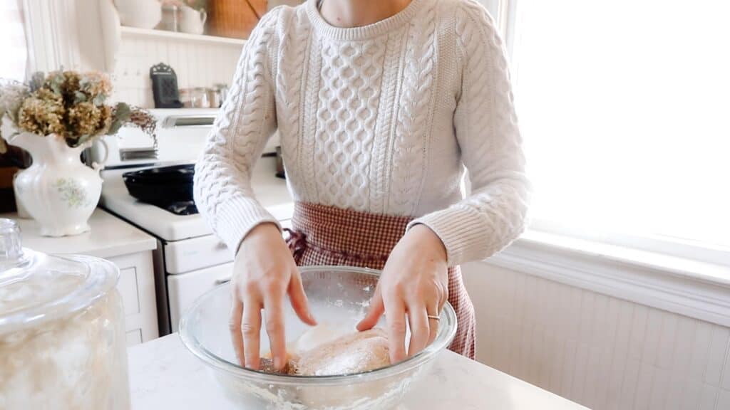 women mixing sourdough cookies together with her hands