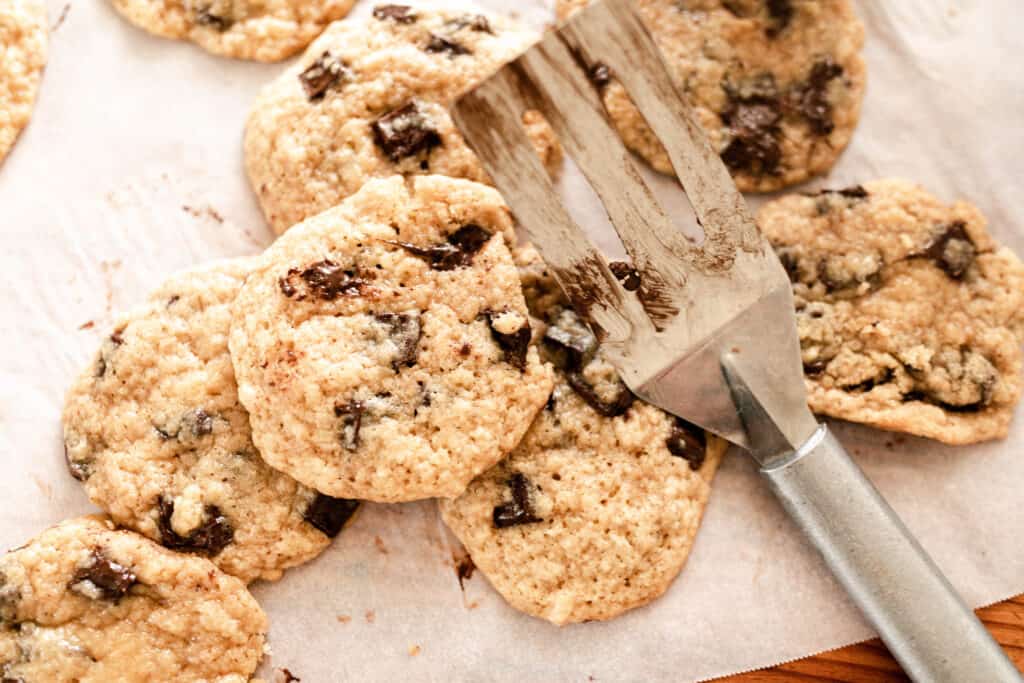 chocolate chip cookies stacked on parchment