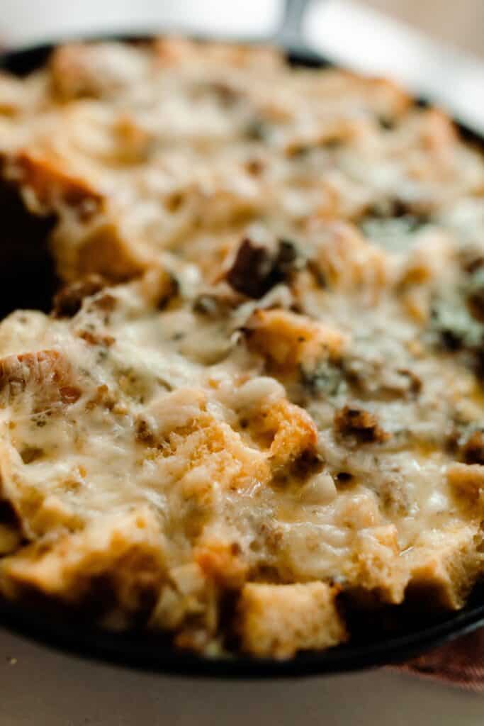cheese topped strata with sausage and herbs