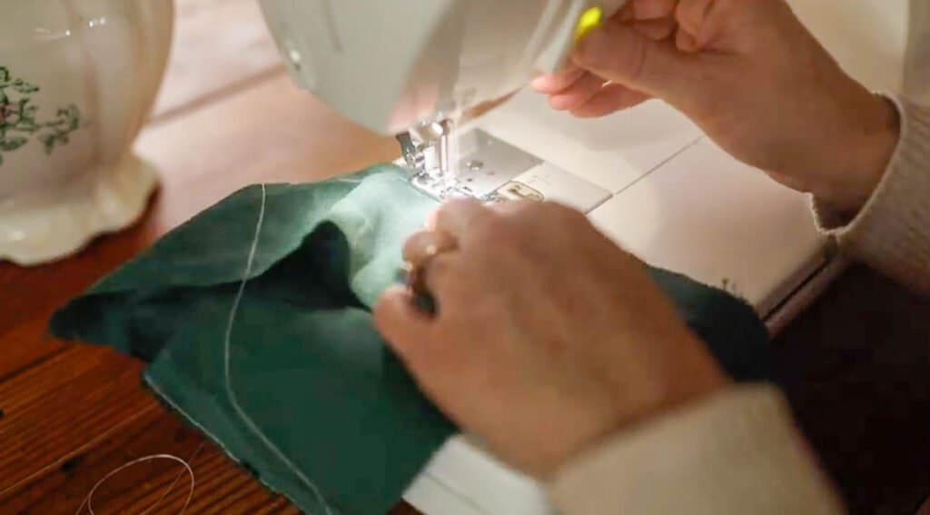 sewing a baby bonnet together on a sewing machine