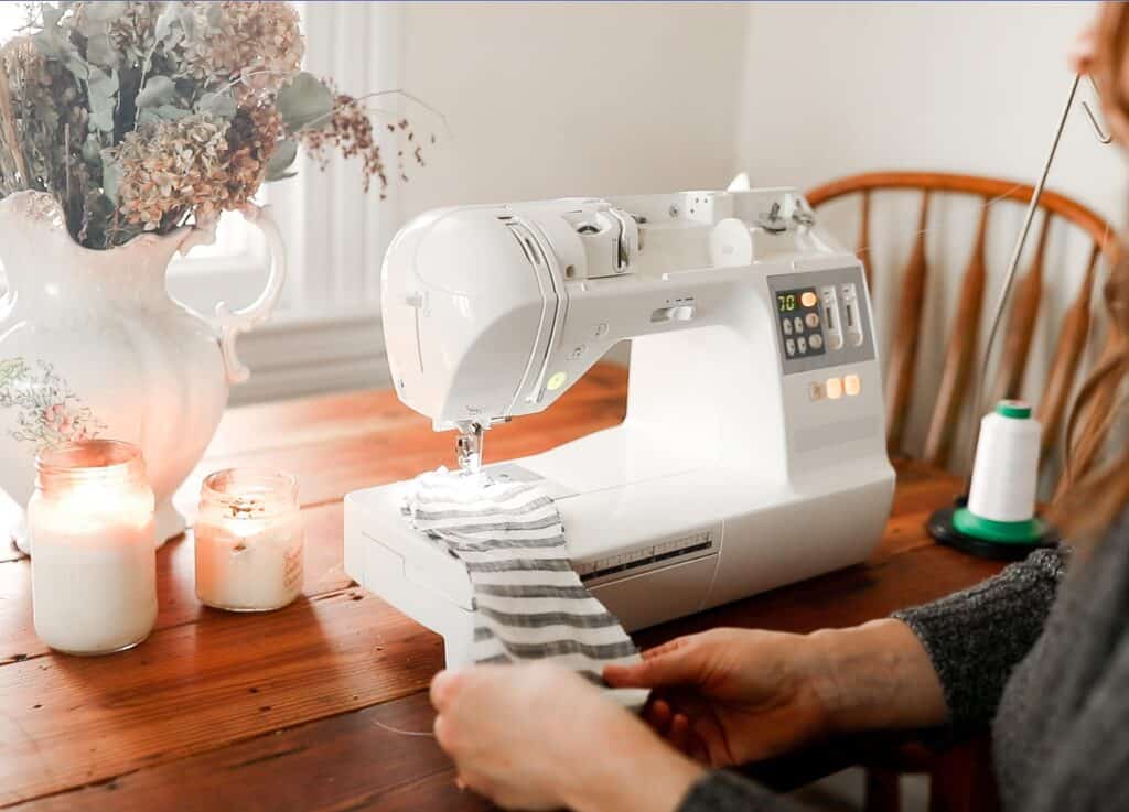 women sewing a bow for a scrunch