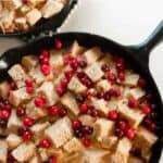 two cast iron skillets with cranberry French toast casserole made with sourdough bread