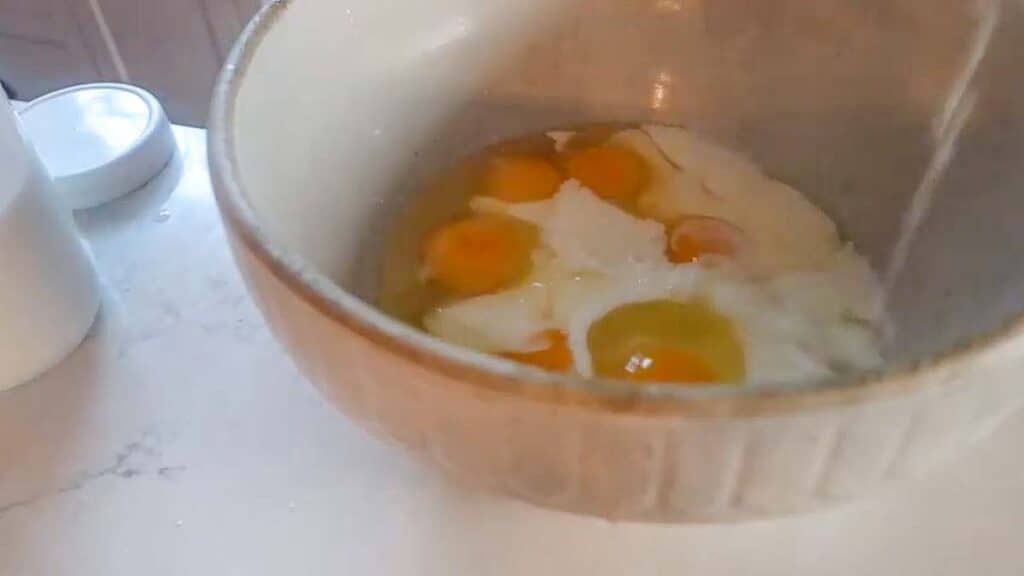 eggs, milk and vanilla in a large antique bowl.