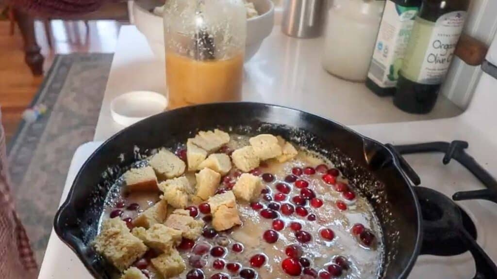 butter, maple syrup, cranberries and bread cubes in a cast iron skillet.