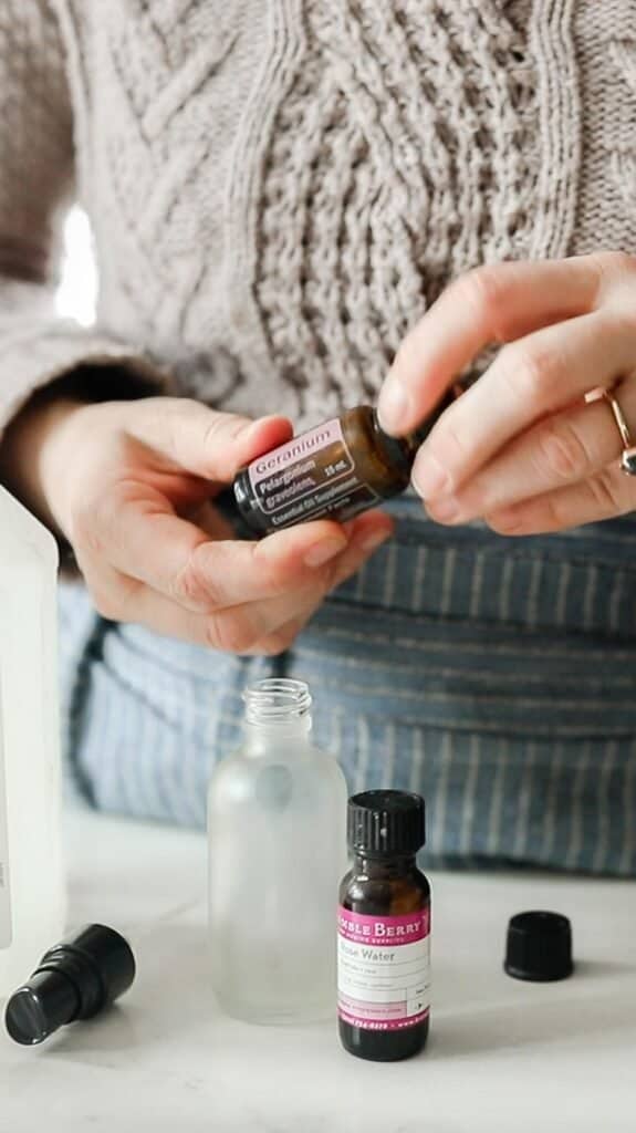 women about to add essential oils into a glass jar to make toner