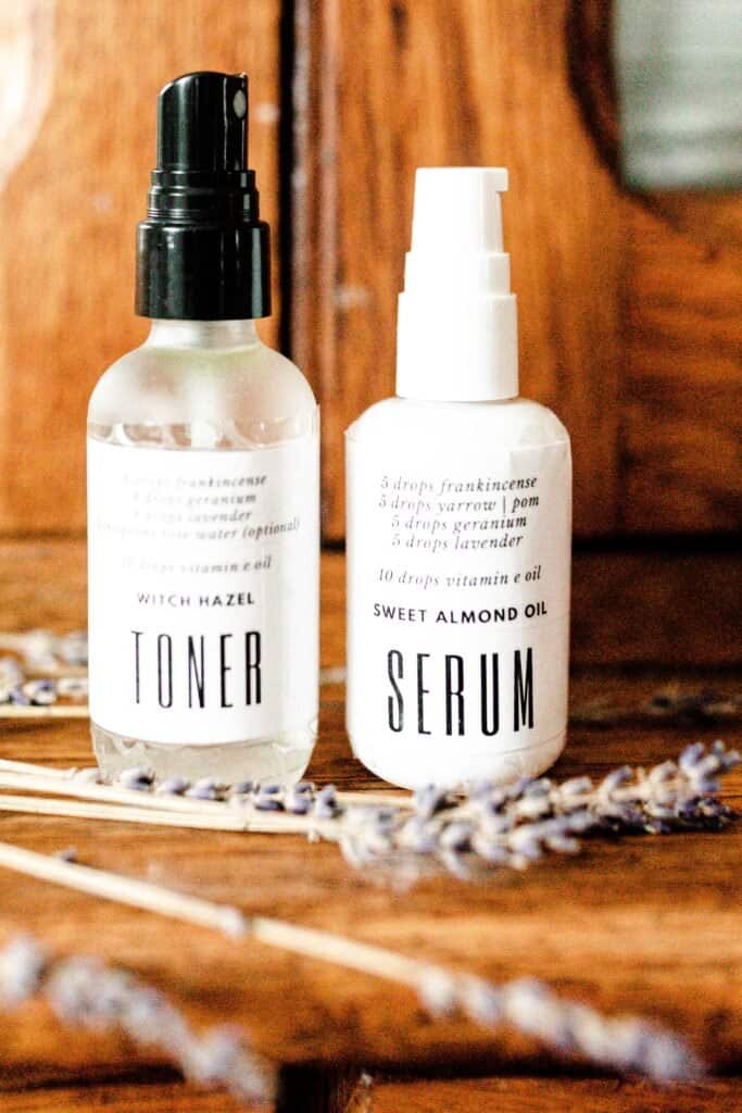 homemade toner and serum in bottles on a wood cabinet with dried lavender