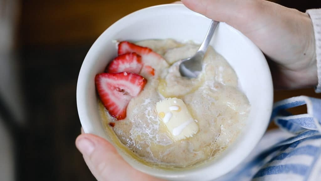 strawberries and a pat of butter in a bowl of einkorn cream of wheat