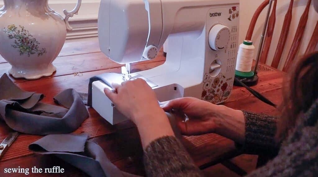 women sewing a ruffle out of flannel fabric on a sewing machine