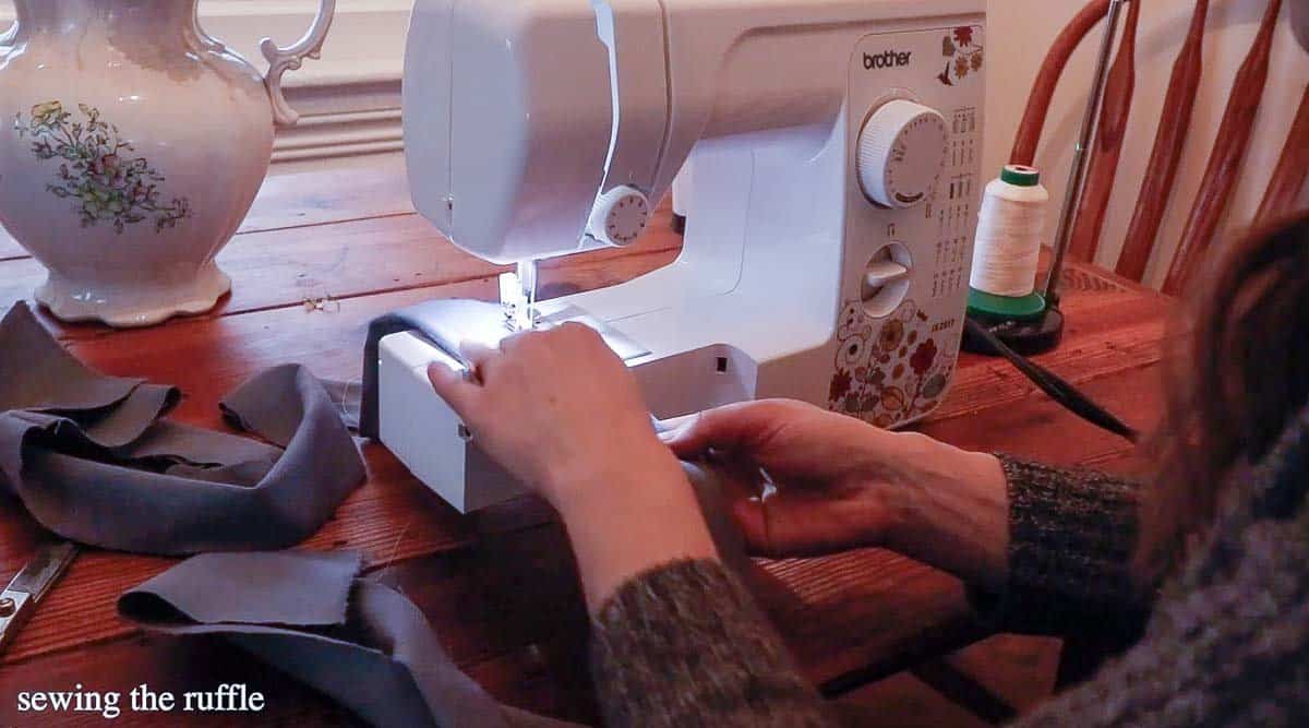 women sewing a ruffle out of flannel fabric on a sewing machine