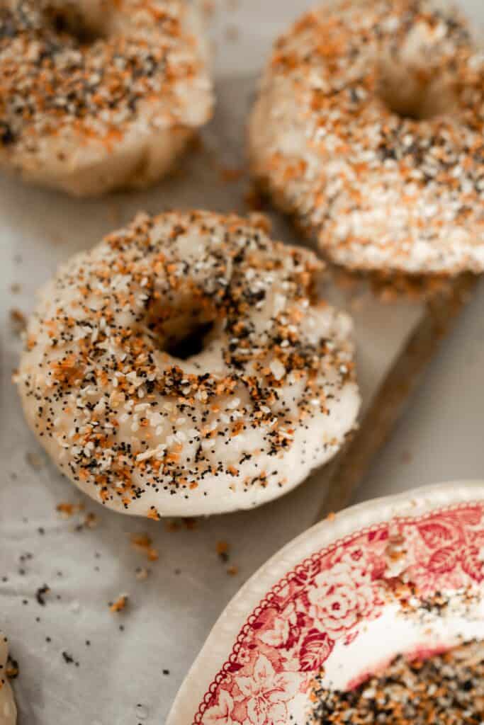 bagel sprinkled with seasonings before baking