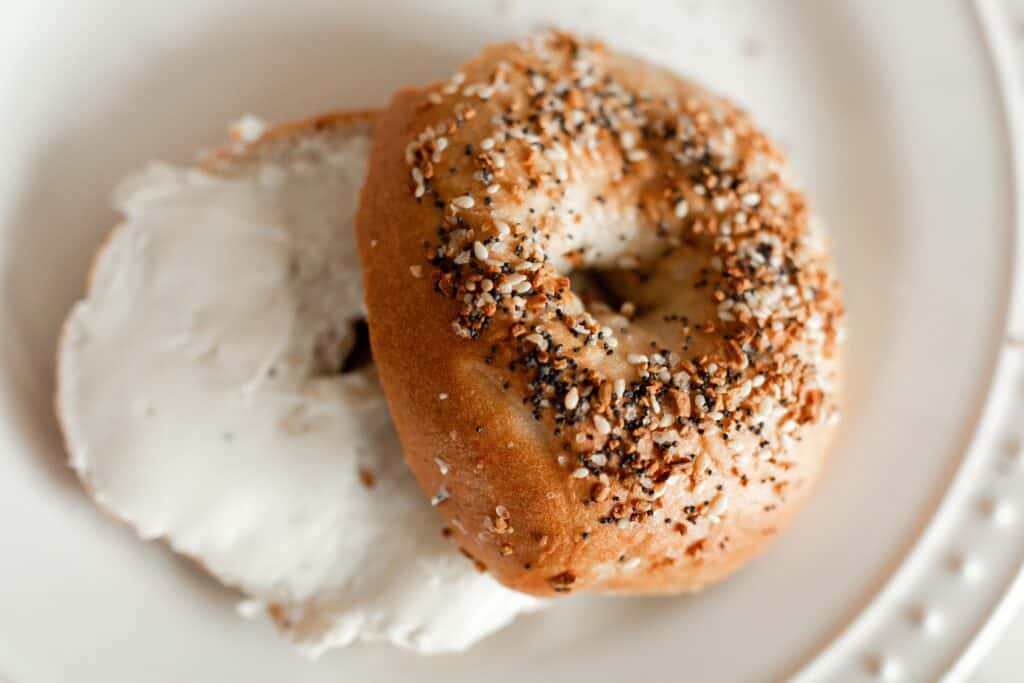 bagel with cream cheese on a white plate