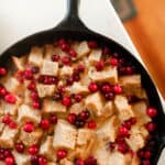 overhead photo of sourdough cranberry French toast casserole in a cast iron skillet