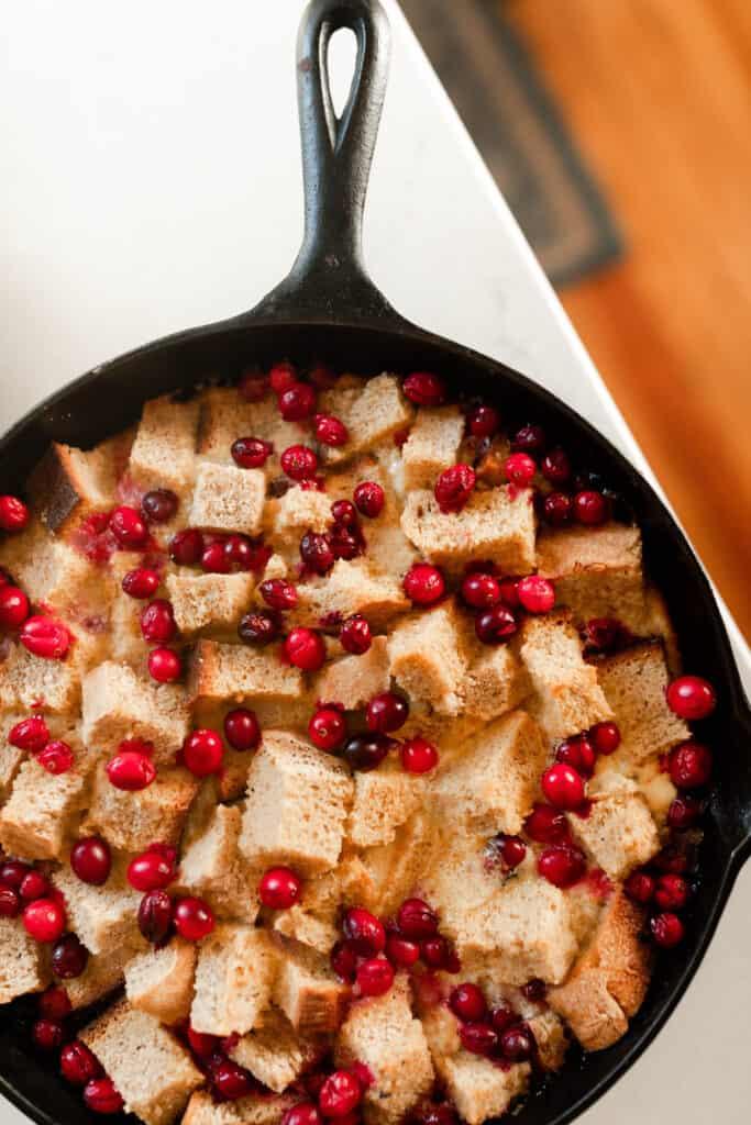 overhead photo of sourdough cranberry French toast casserole in a cast iron skillet