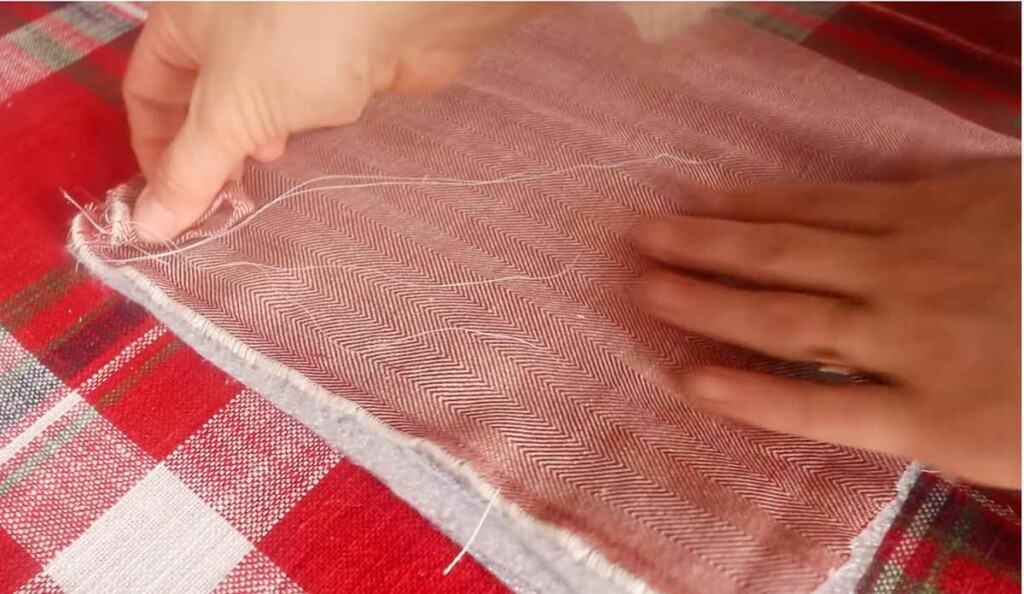 Women putting. a pot holder together by layering fabric and batting