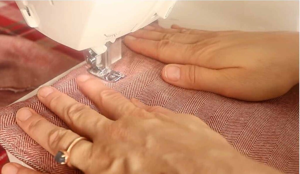 sewing down the center of a pot holder to hold the fabric together