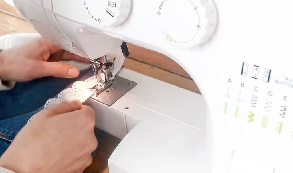 sewing eyelet trim onto a denim skirt