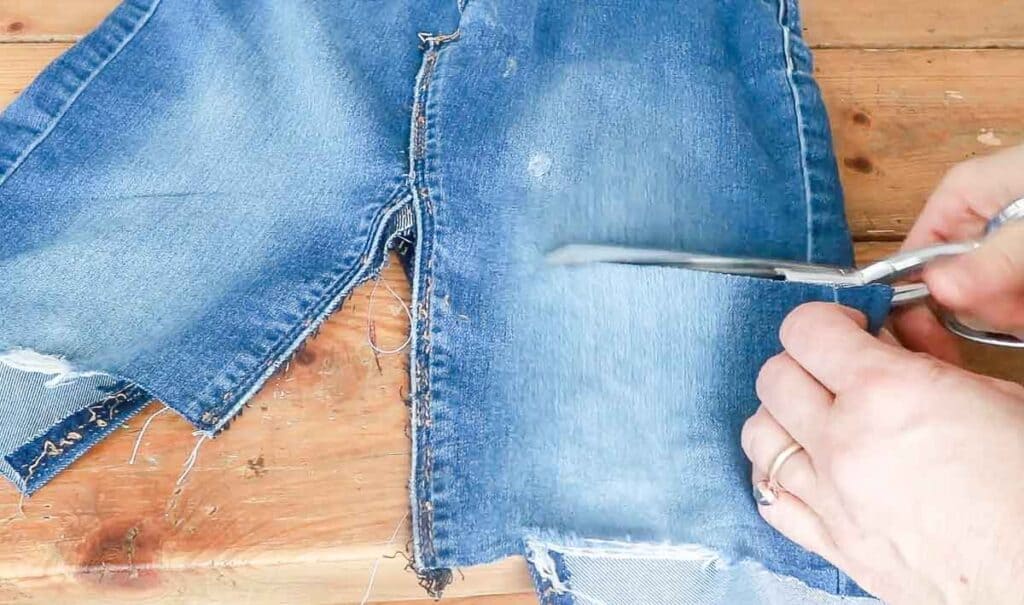 trimming off extra denim materials from a jean skirt