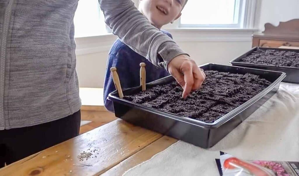 women and son starting seeds for a garden