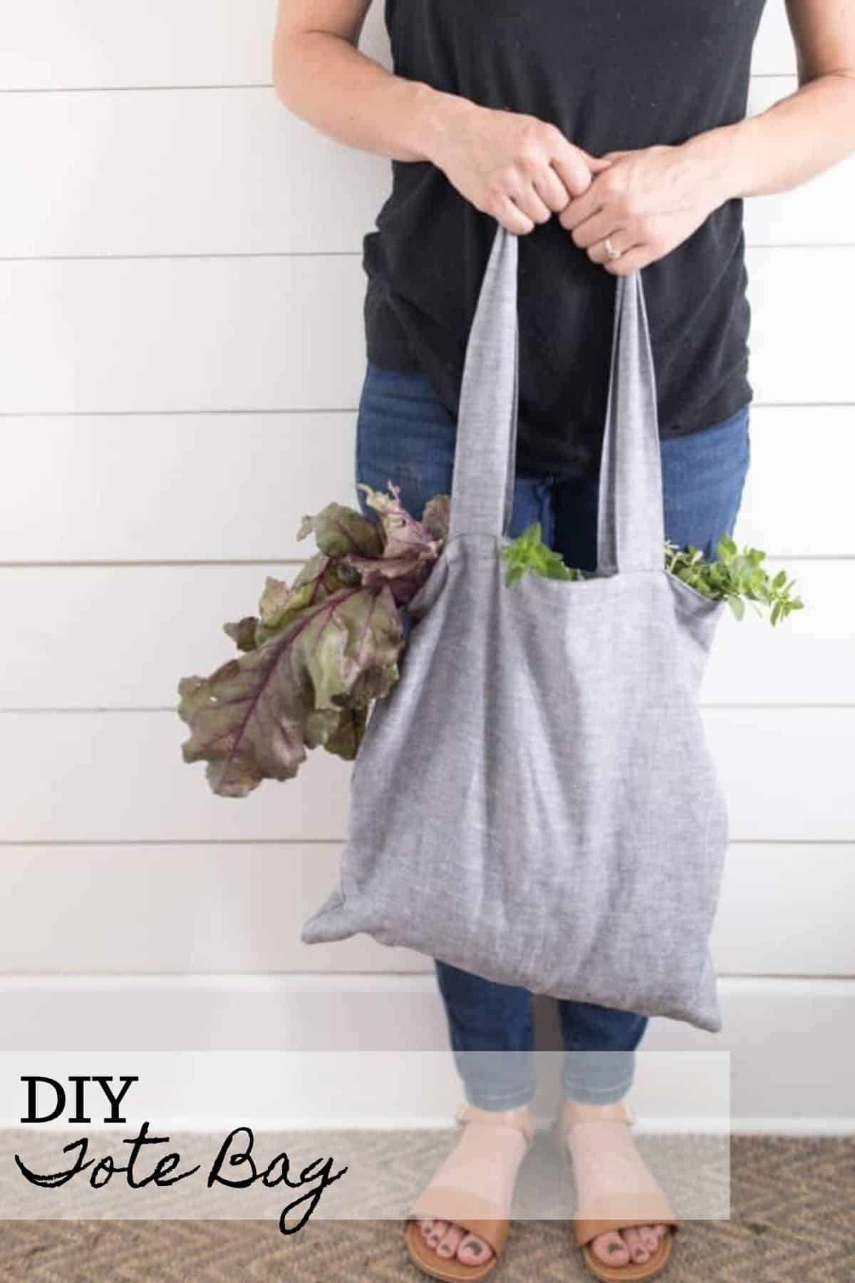women wearing a black shirt and jeans holding a DIY tote bag full of lettuce