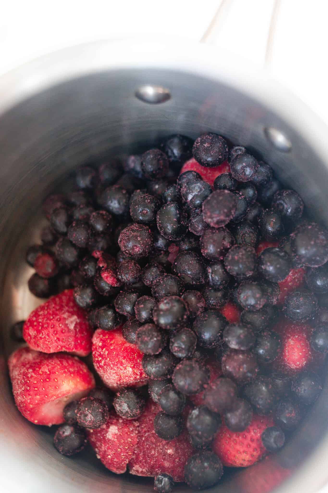 Berries in a saucepan to make berry syrup.