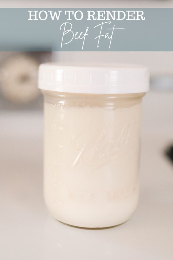 rendered beef fat in a mason jar with a white plastic lid on a white antique stove