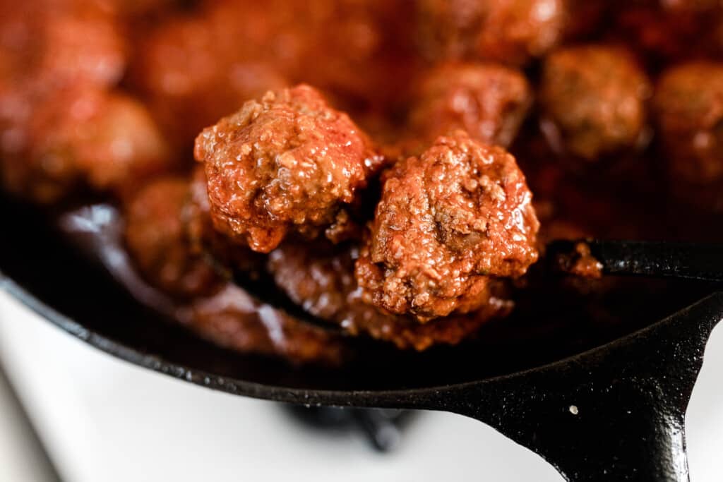 meatballs in pasta sauce in a cast iron skillet